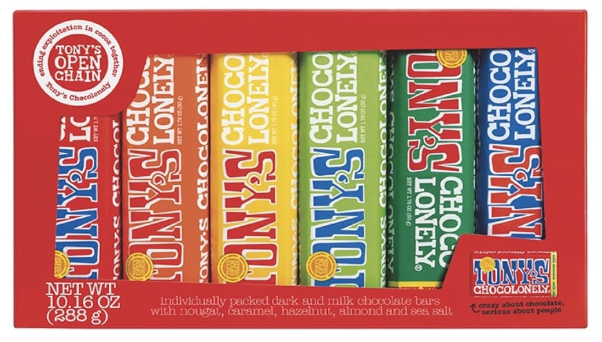 A festive box of chocolate Christmas treats holds six Tony's Chocolonely bars, each in vibrant wrappers: red, blue, yellow, and green. Enjoy flavors like nougat, caramel, hazelnut, almond, and sea salt. The box proudly displays "Tony's Open Chain" and weighs 10.16 oz (288 g).